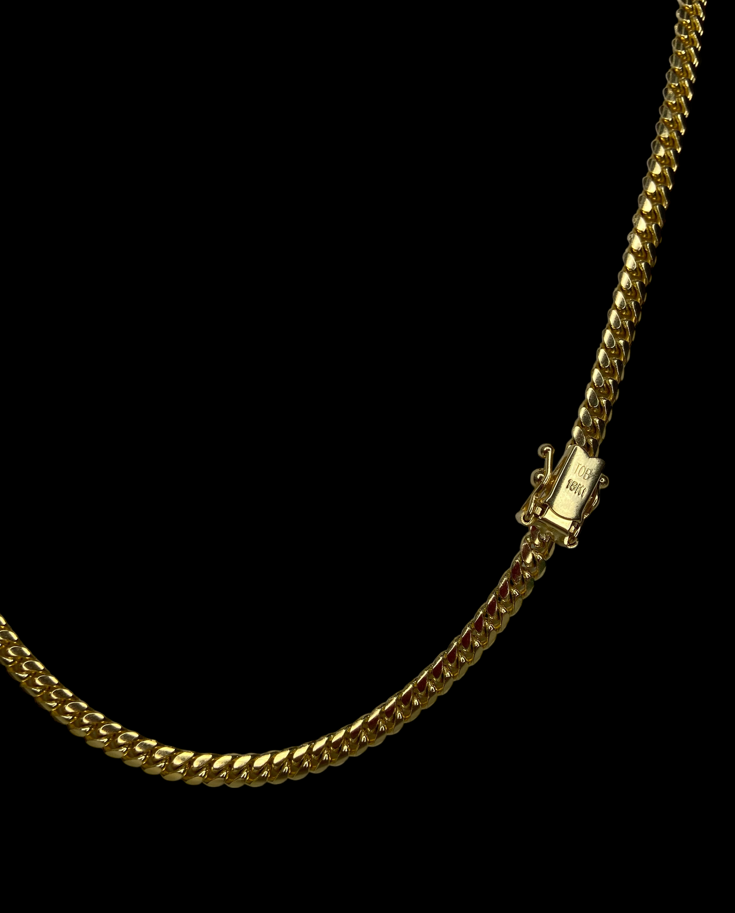 Gold chain necklace with a box clasp on a black background
