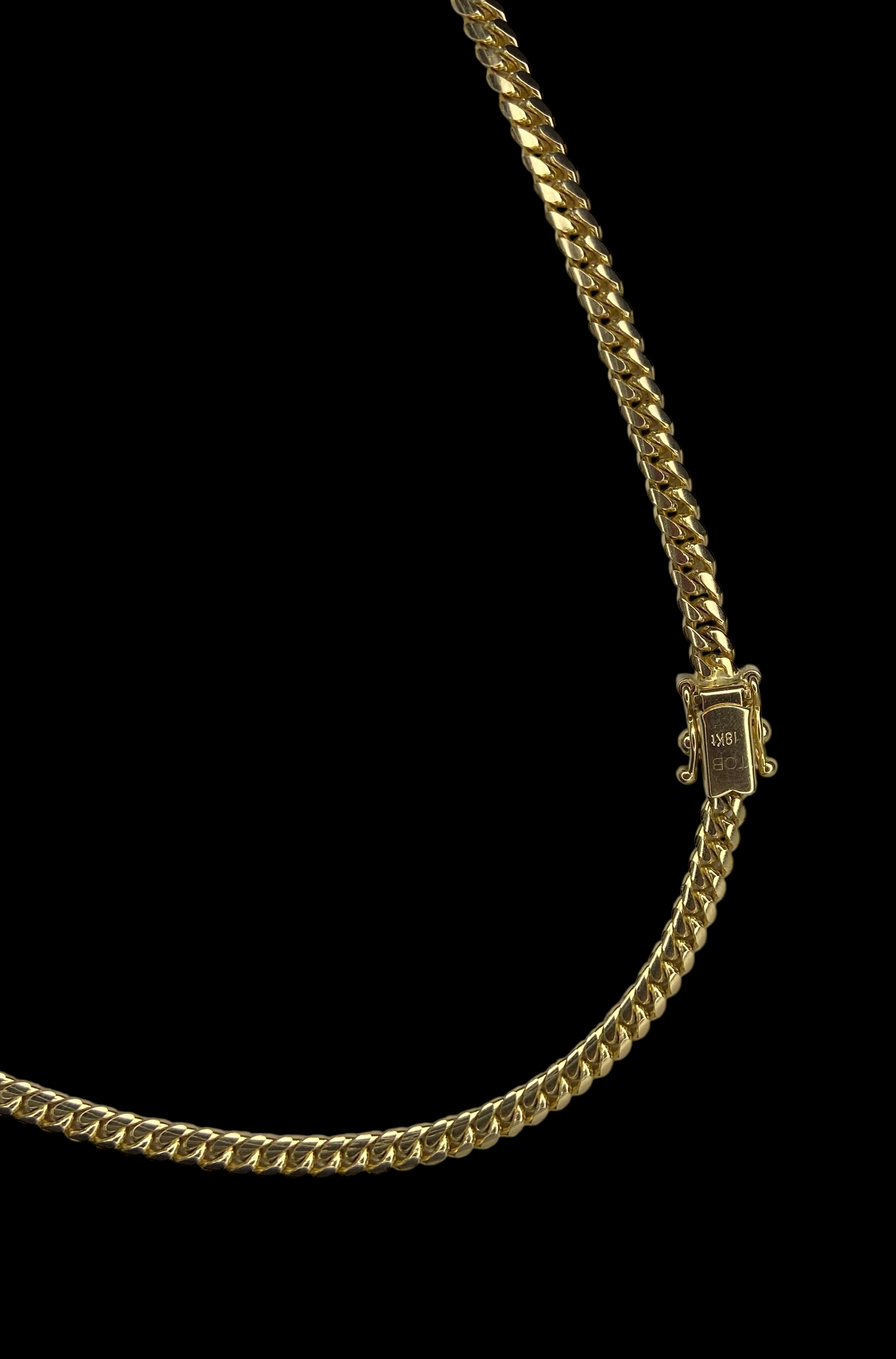 Gold chain necklace with a box clasp on a black background
