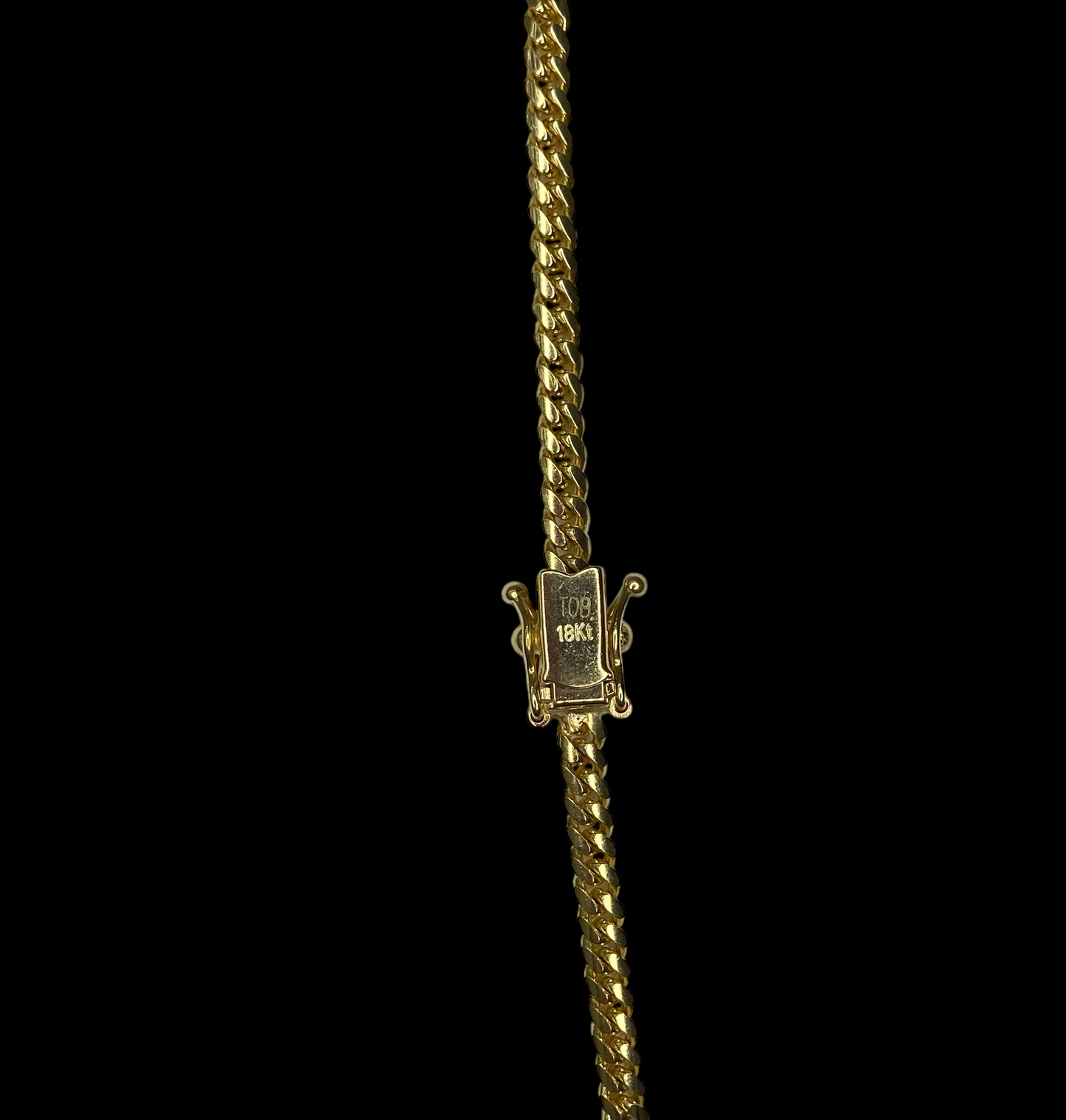 Gold necklace with a box clasp on a black background