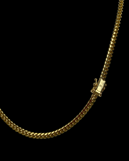 Gold chain necklace with a box clasp on a black background
