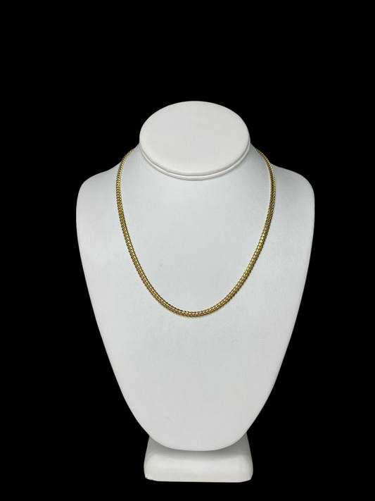 18KT Yellow Gold Cuban Link Chain necklace (18" and 3.8 mm) on a white mannequin bust against a black background