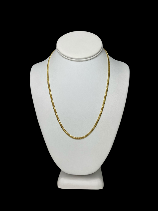 18KT Yellow Gold Cuban Chain Link necklace on a white mannequin bust against a black background