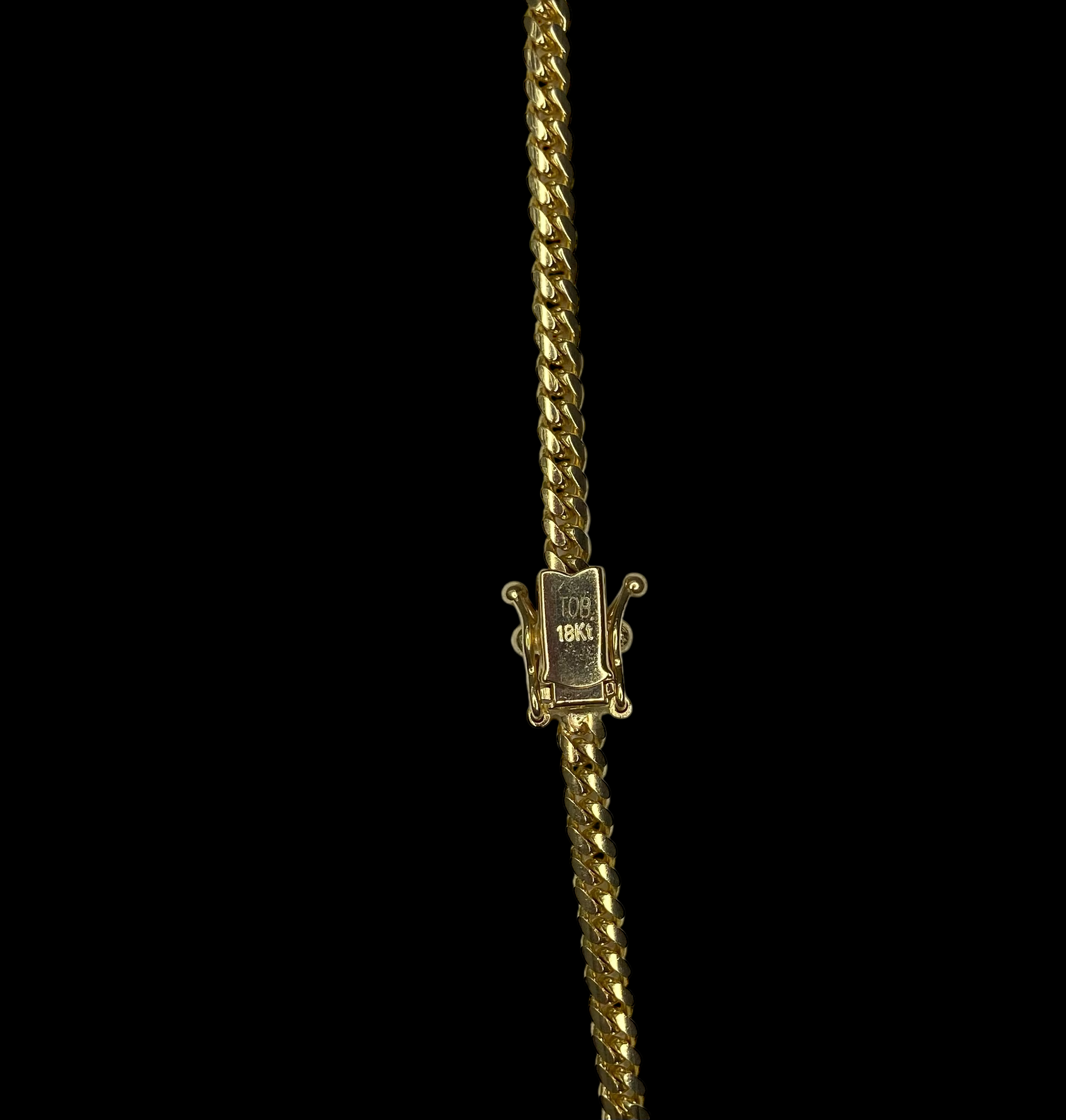 Gold necklace with a box clasp on a black background