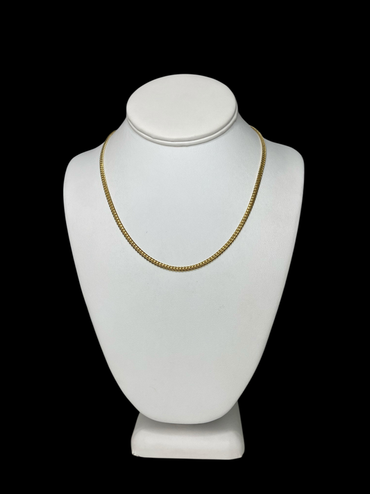 18KT Yellow Gold Cuban Link Chain necklace (18" and 3 mm) on a white mannequin bust against a black background